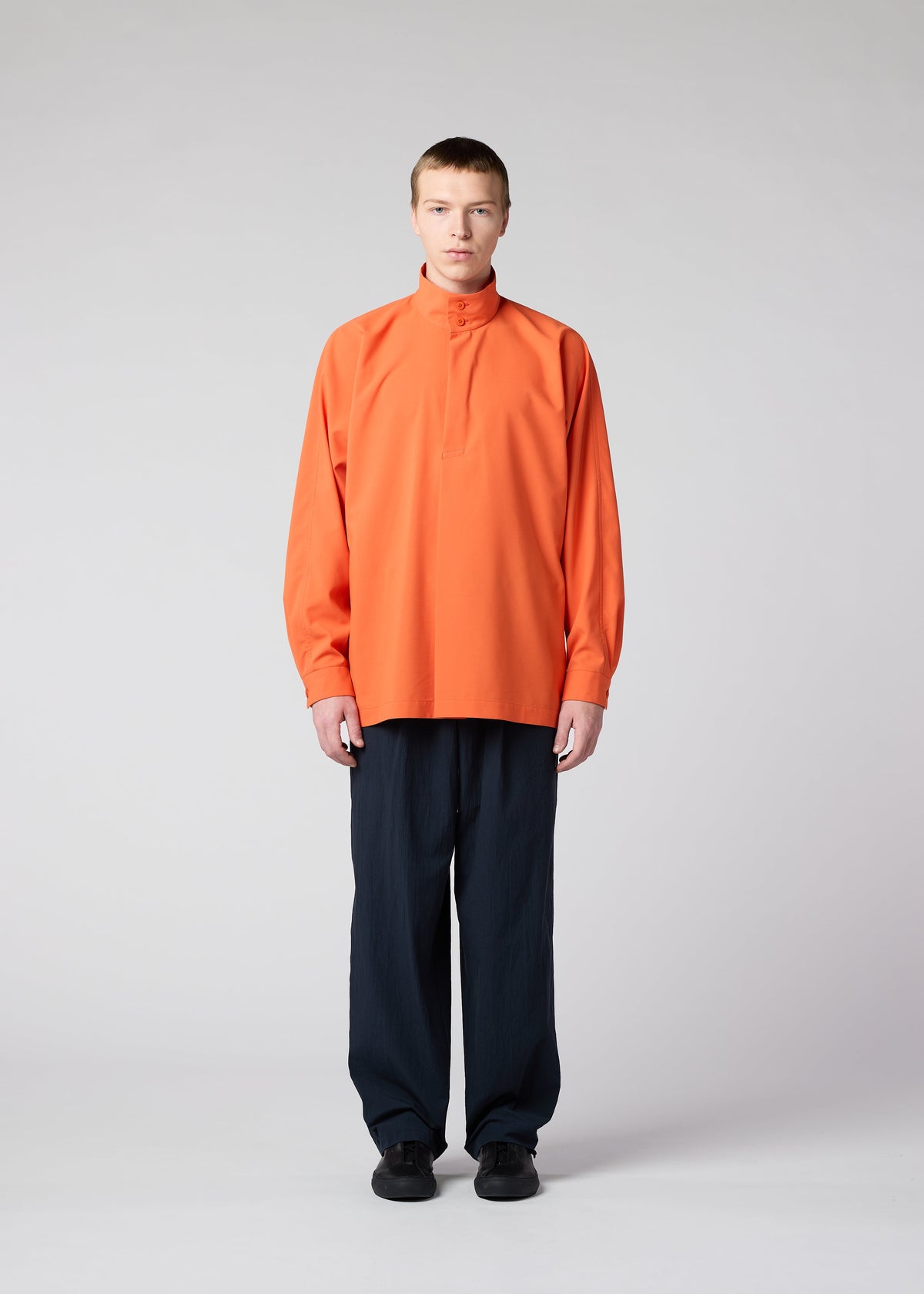 A model wears the IM MEN NAVY BOTTOMS trousers.