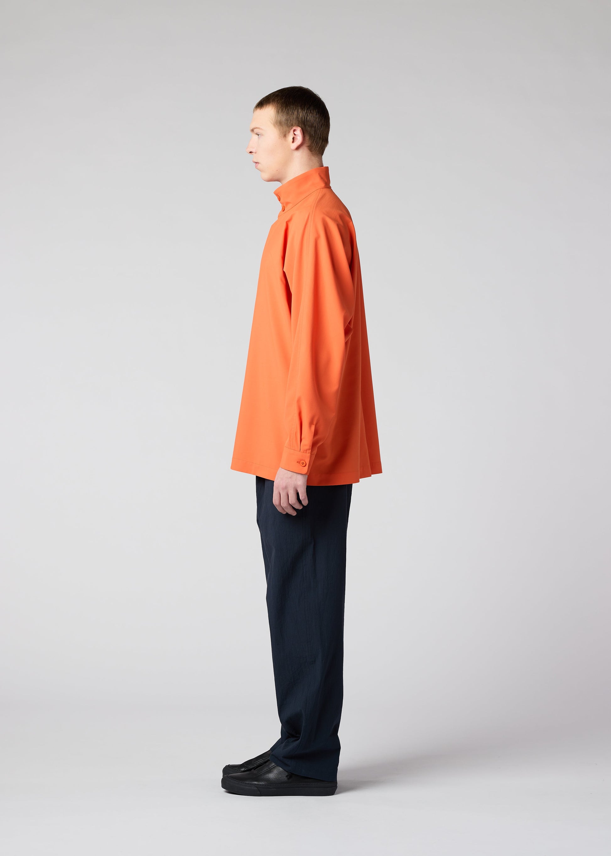 A model wears the IM MEN NAVY BOTTOMS trousers.