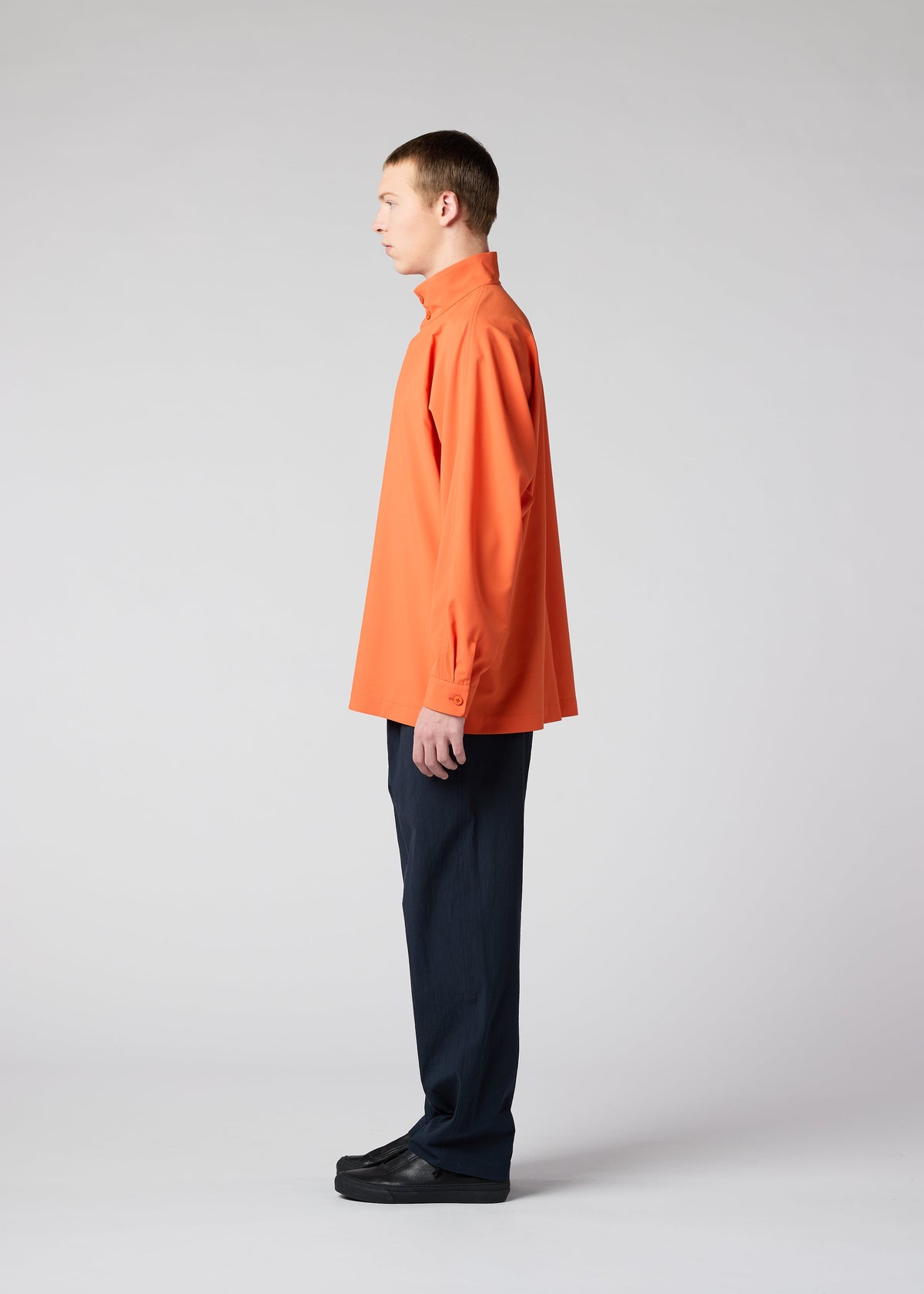 A model wears the IM MEN NAVY BOTTOMS trousers.
