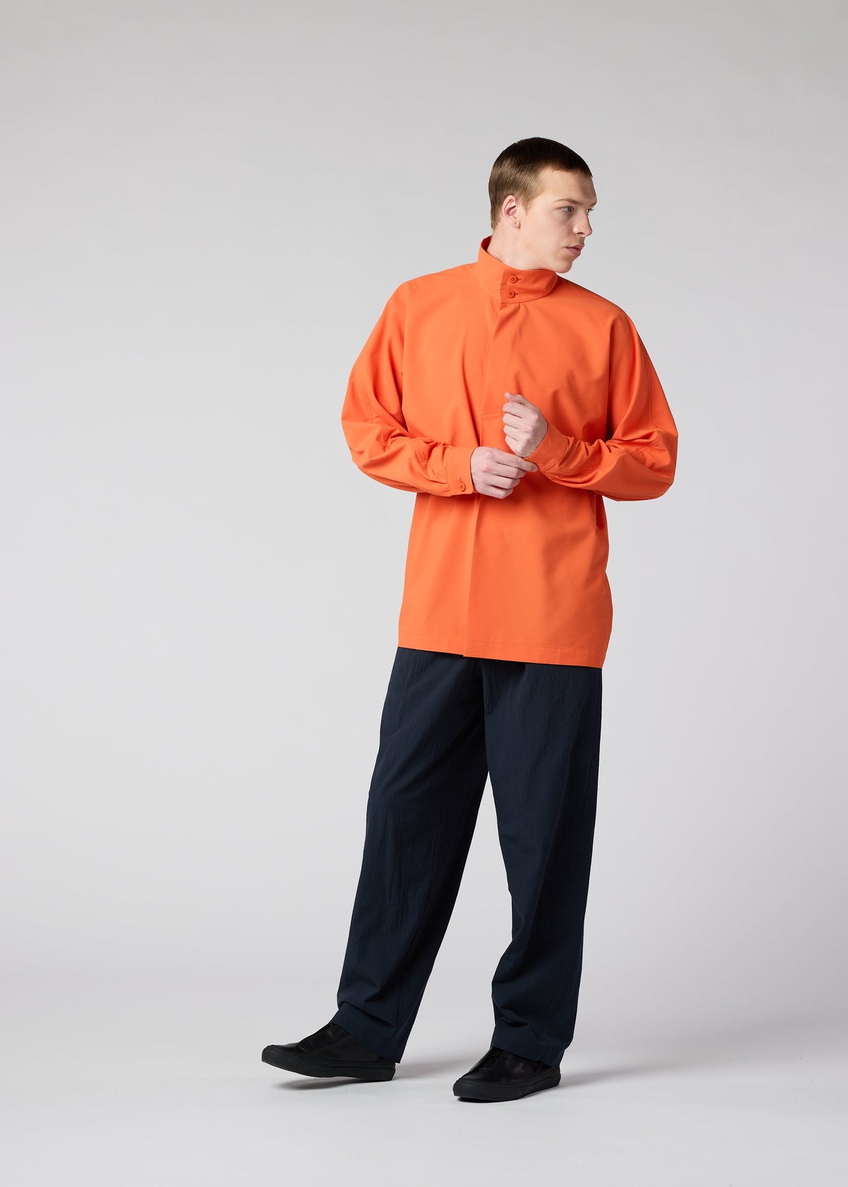 A model wears the IM MEN NAVY BOTTOMS trousers.