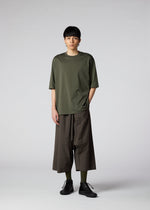 A model wears the IM MEN NAVY BOTTOMS trousers.