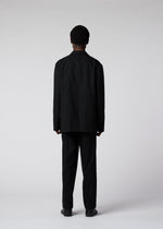A model wears the IM MEN FLY WOOL trousers.