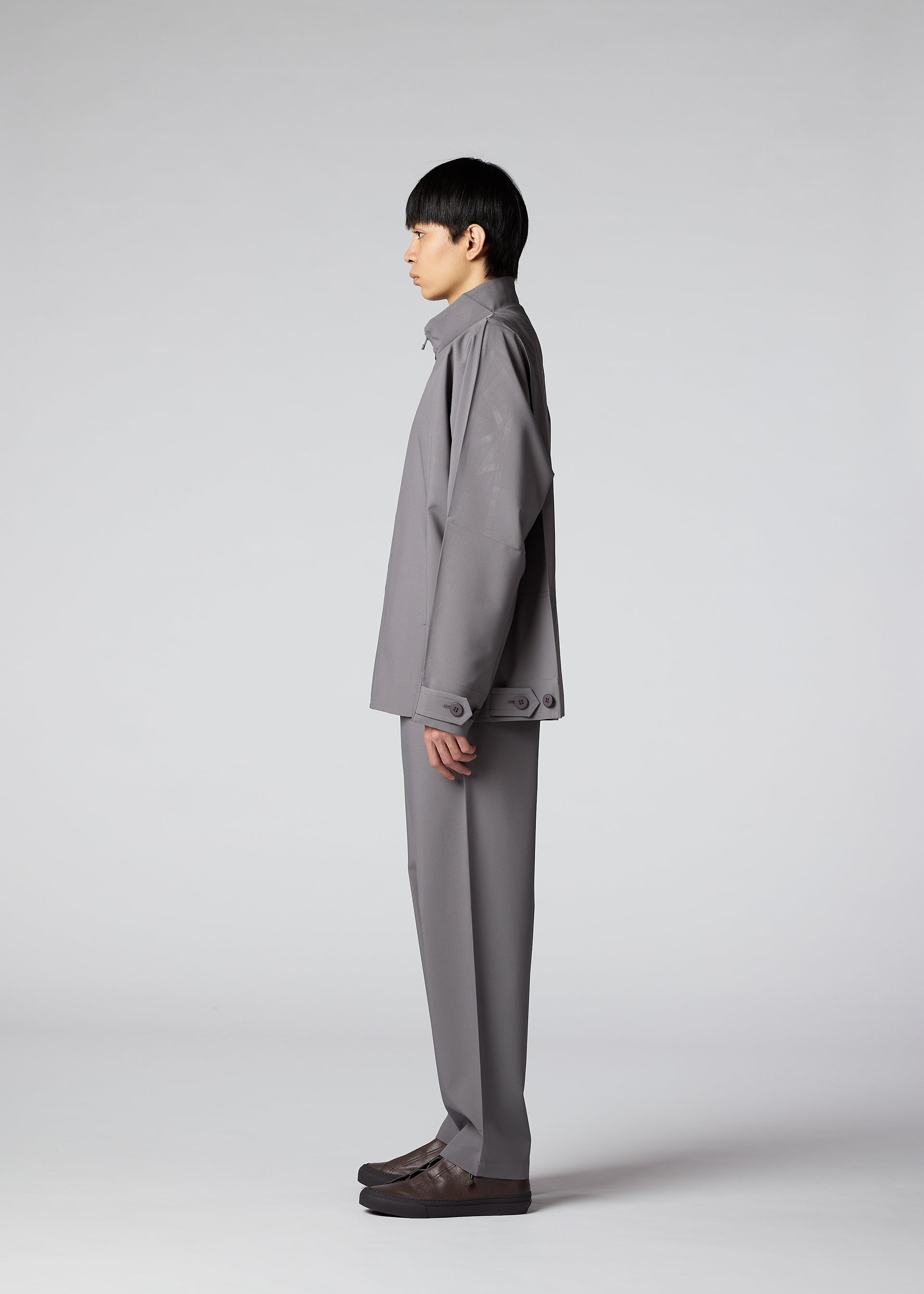 A model wears the IM MEN FLAT clothing.
