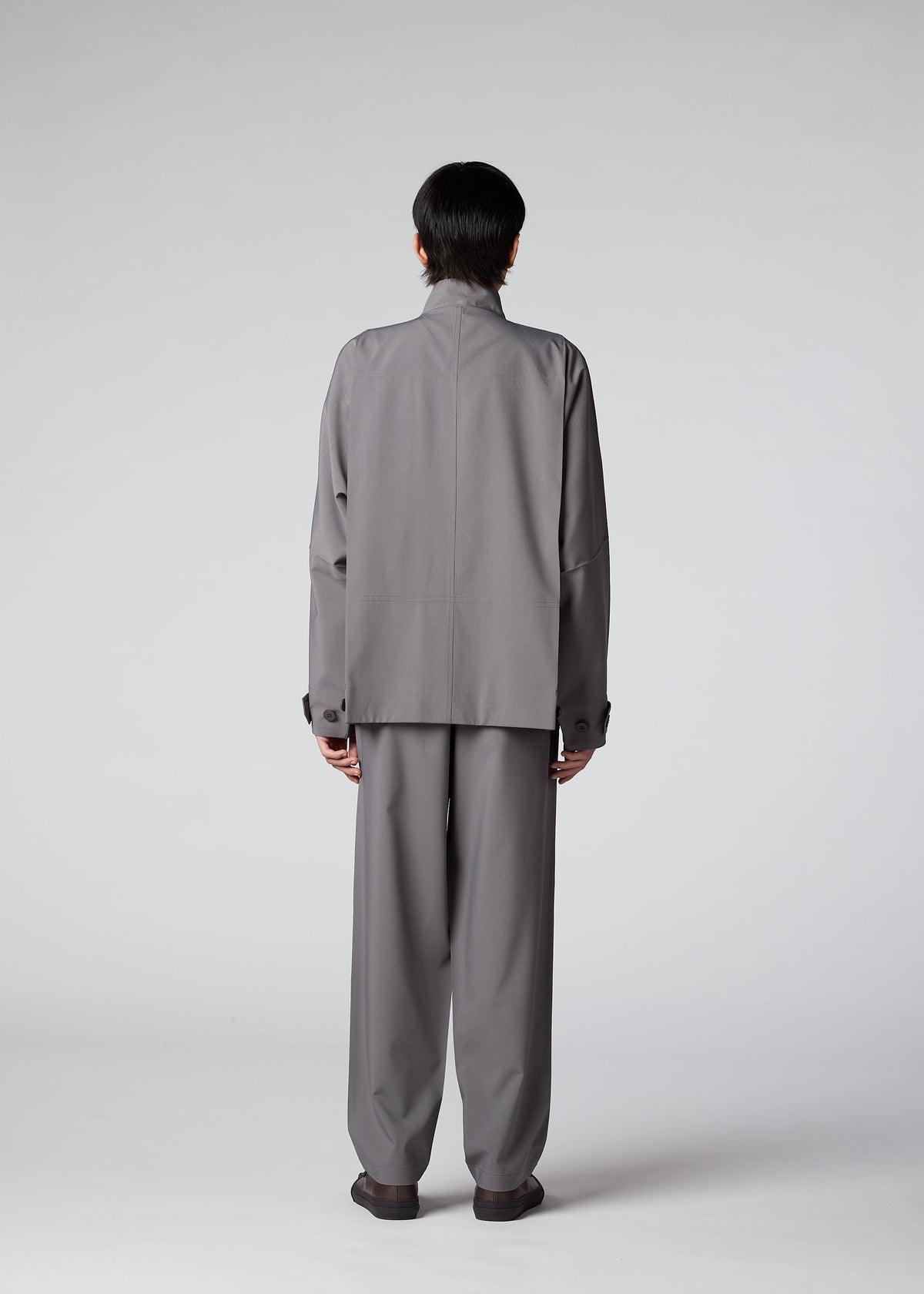 A model wears the IM MEN FLAT clothing.