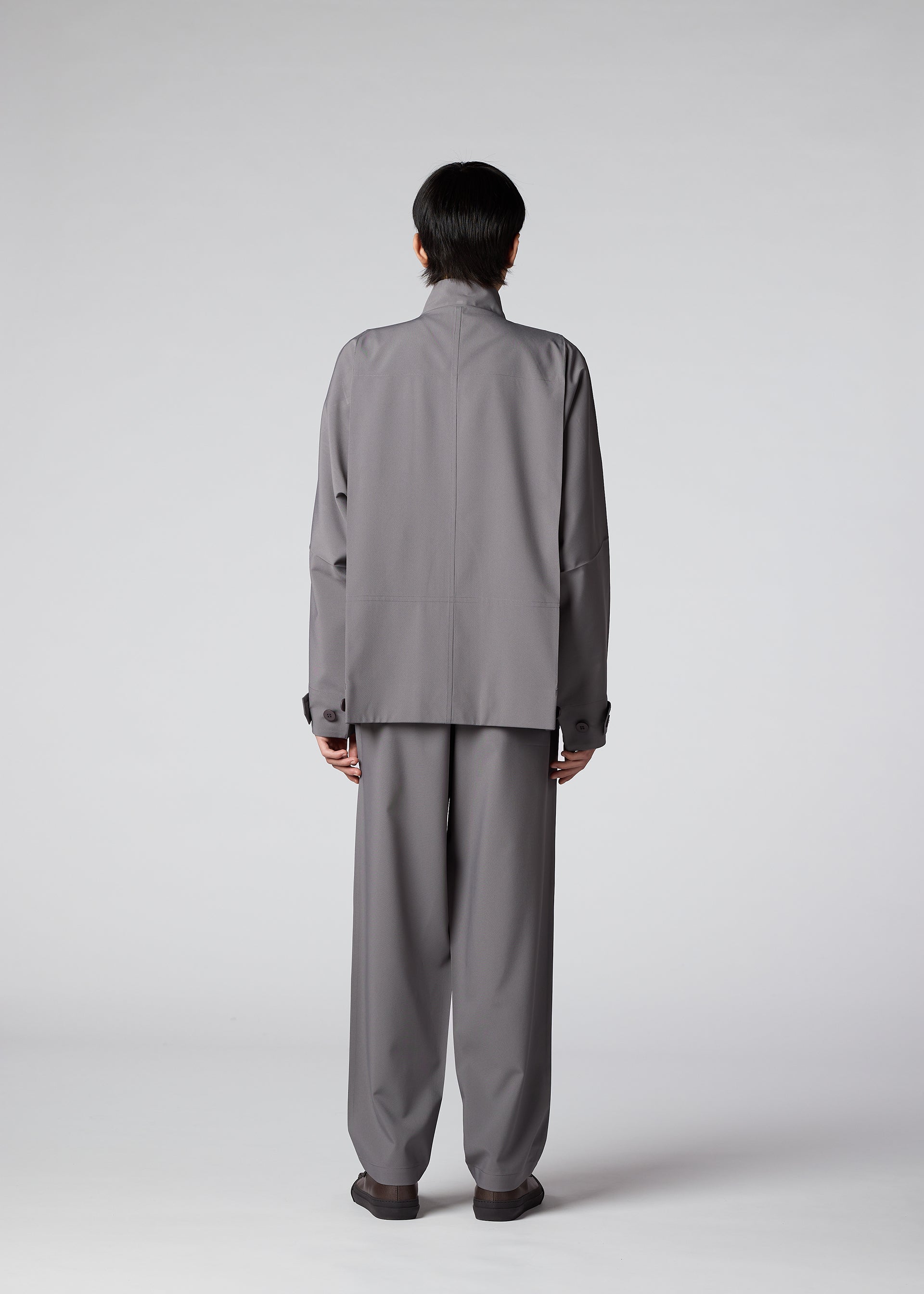 A model wears the IM MEN FLAT clothing.
