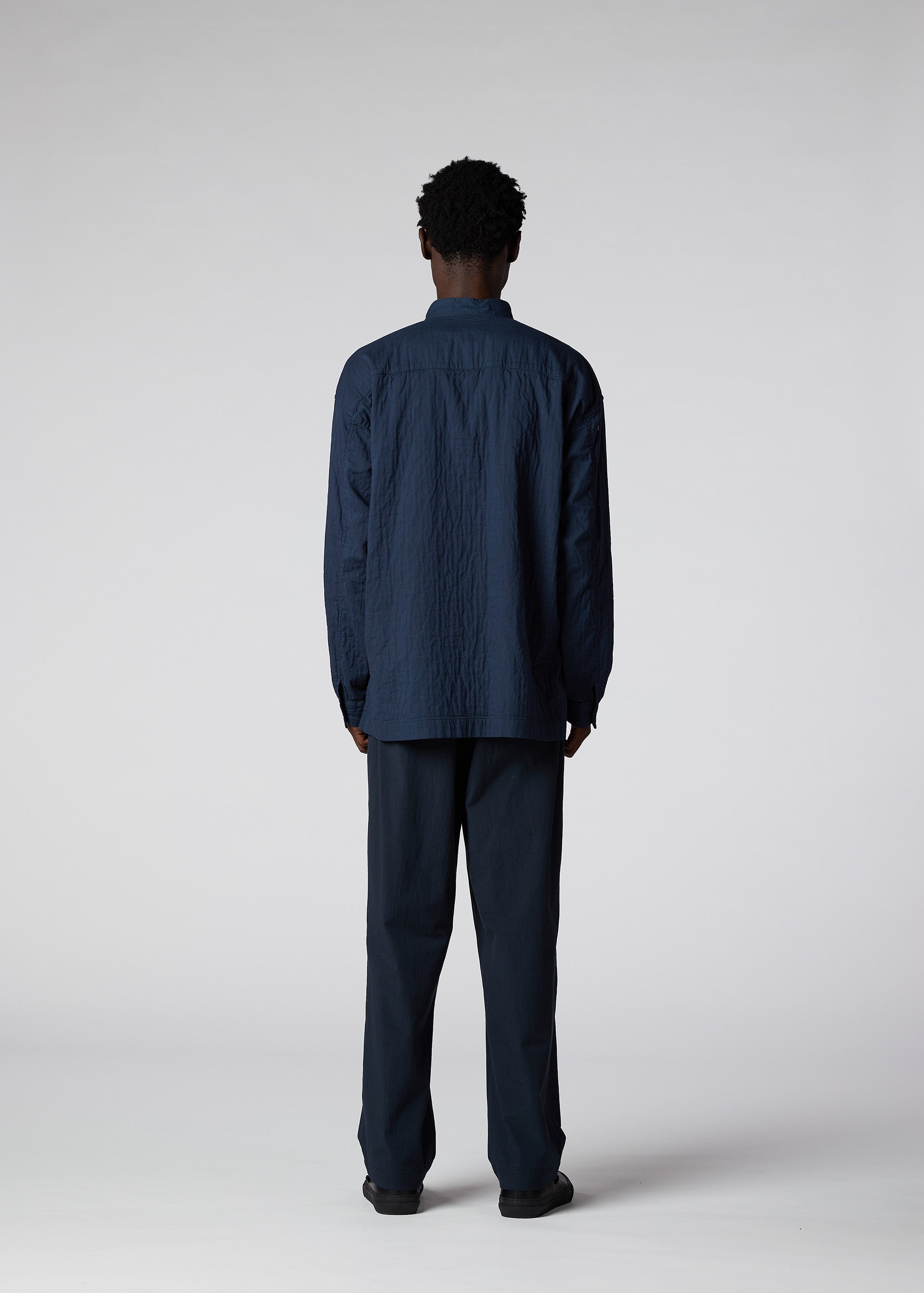 A model wears the IM MEN DOUBLE FACE COTTON SHIRT shirt.