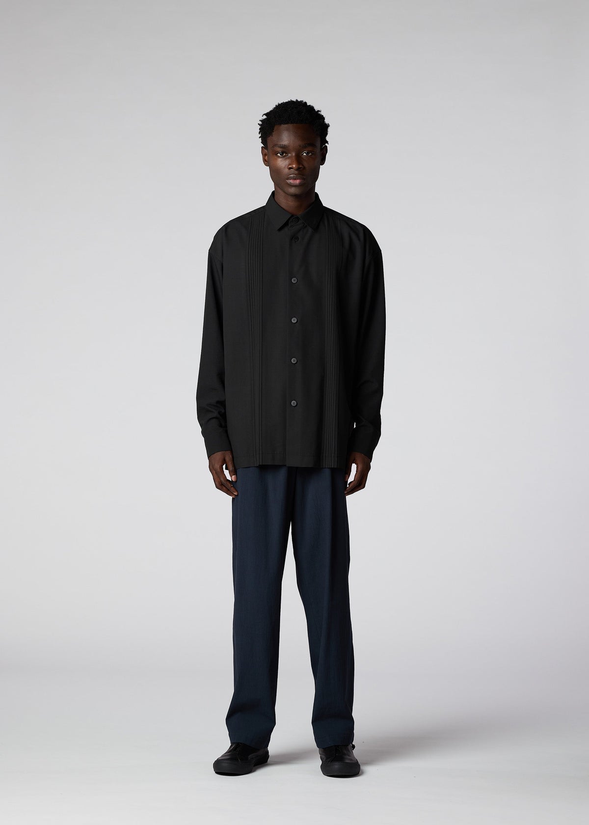 A model wears the IM MEN PLEATS SHIRT shirt.