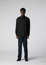 A model wears the IM MEN PLEATS SHIRT shirt.