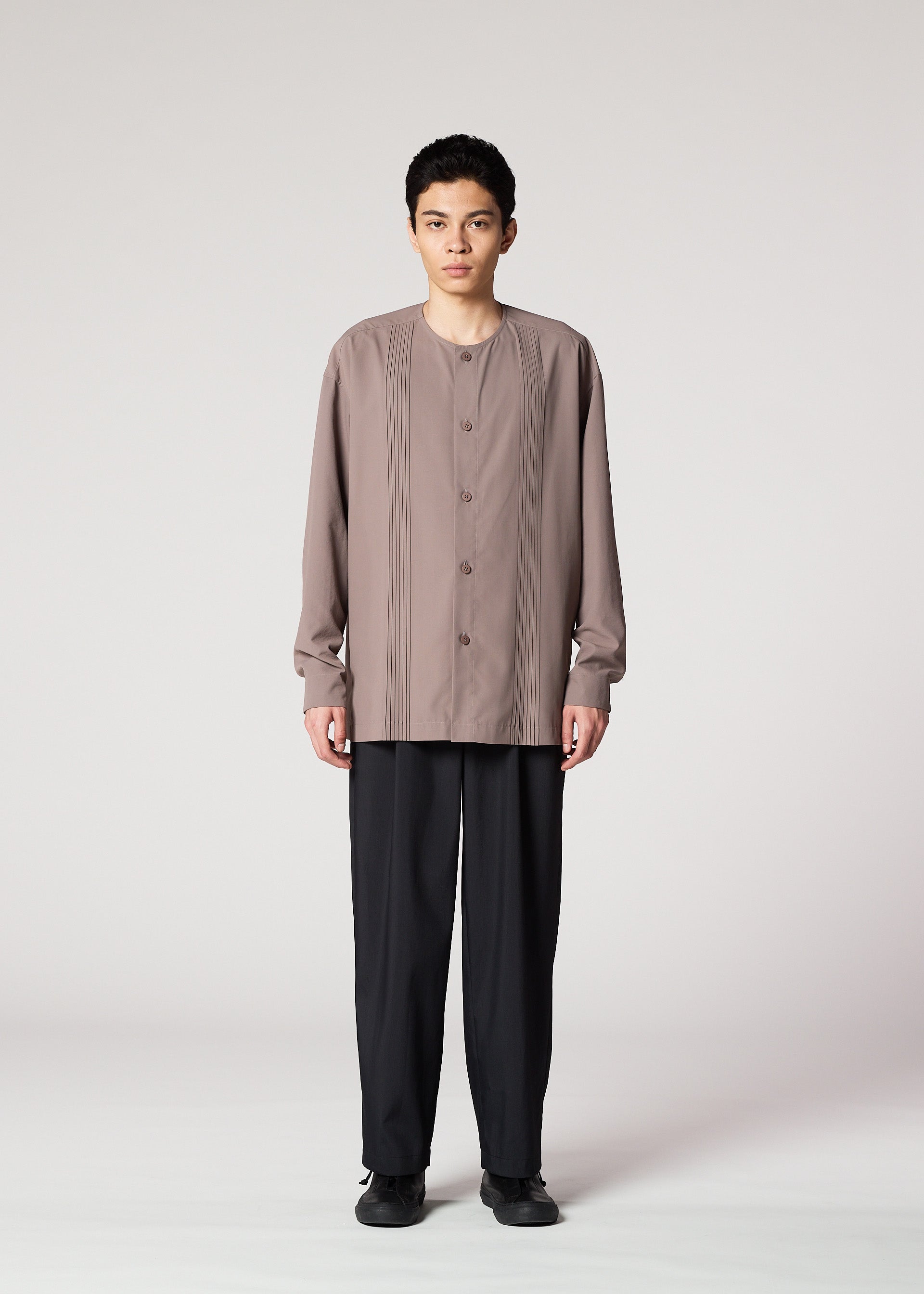 A model wears the IM MEN PLEATS SHIRT shirt.