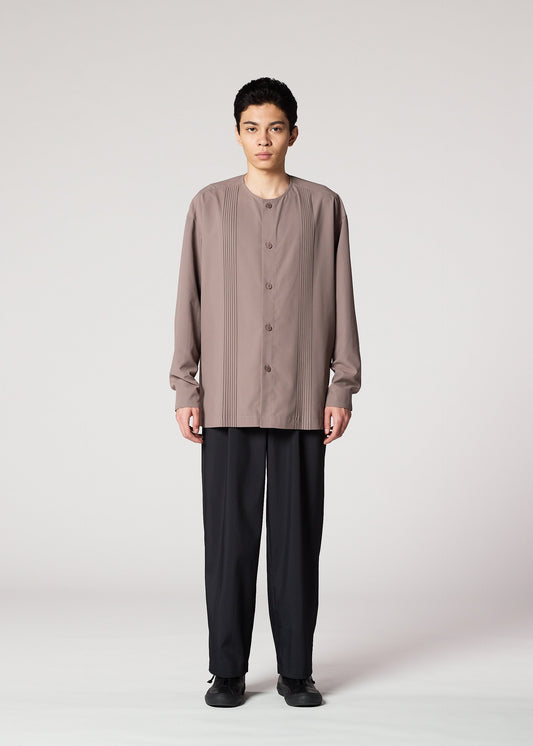A model wears the IM MEN PLEATS SHIRT shirt.