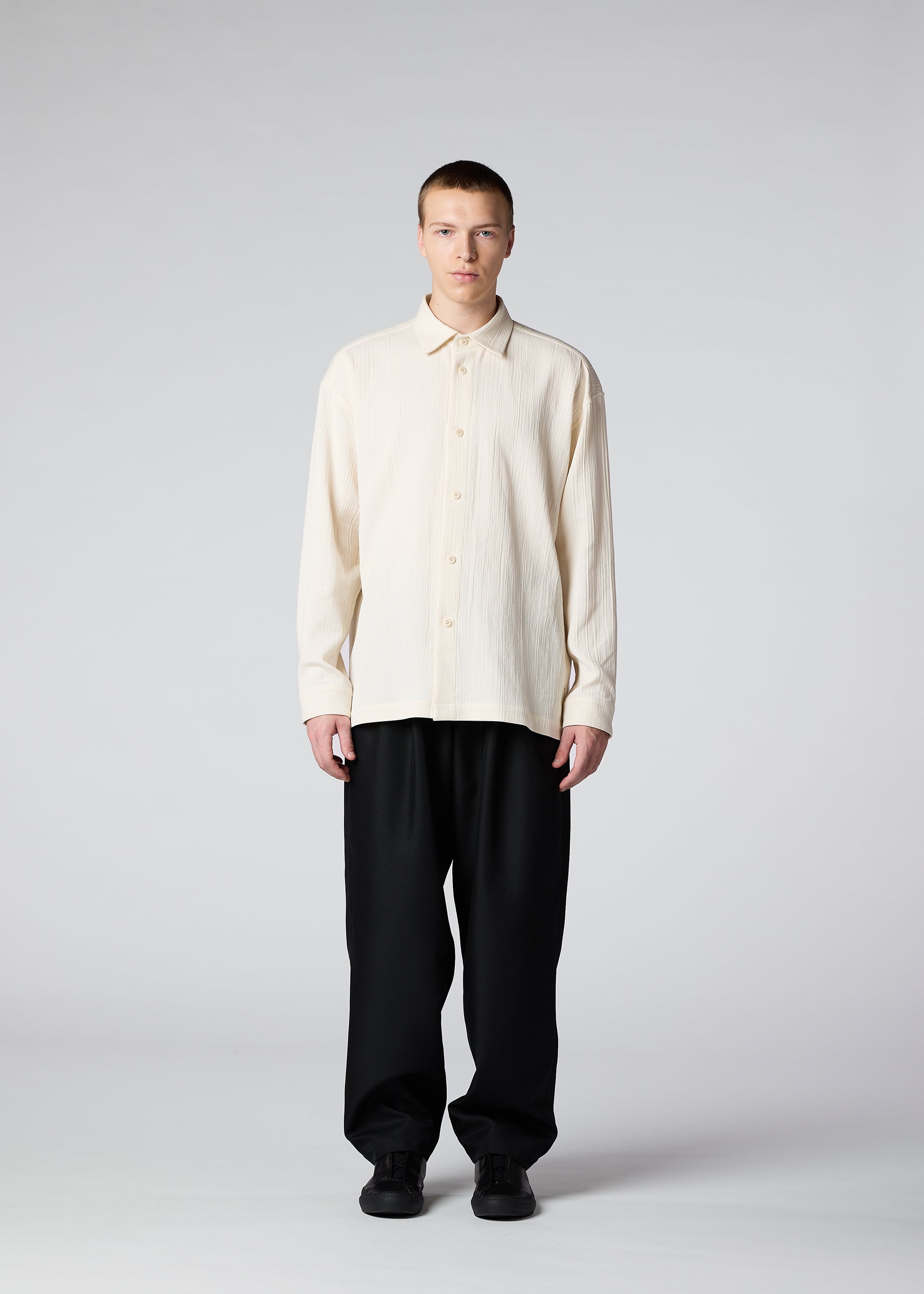 A model wears the IM MEN DOUBLE WEAVE CREPE shirt.