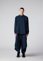 A model wears the IM MEN FLAT DRAPE clothing.