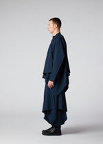 A model wears the IM MEN FLAT DRAPE clothing.