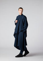 A model wears the IM MEN FLAT DRAPE clothing.