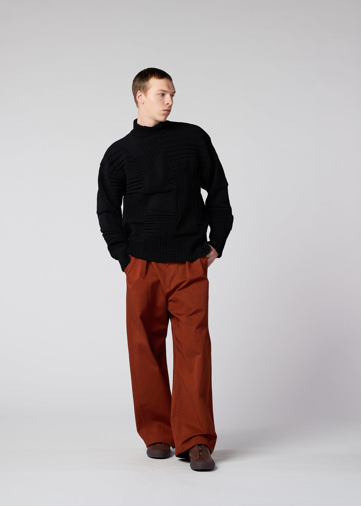 A model wears the IM MEN DEKOBOKO KNIT top.