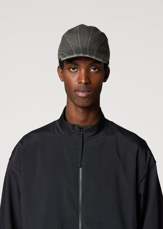 A model wears the IM MEN CARVED CAP hat.