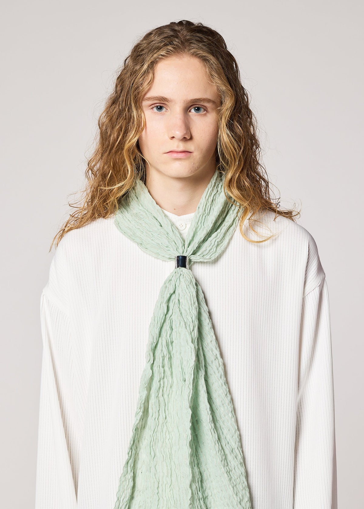 A model wears the IM MEN SHRINK BORDER STOLE stole.