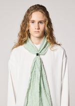 A model wears the IM MEN SHRINK BORDER STOLE stole.