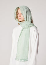 A model wears the IM MEN SHRINK BORDER STOLE stole.
