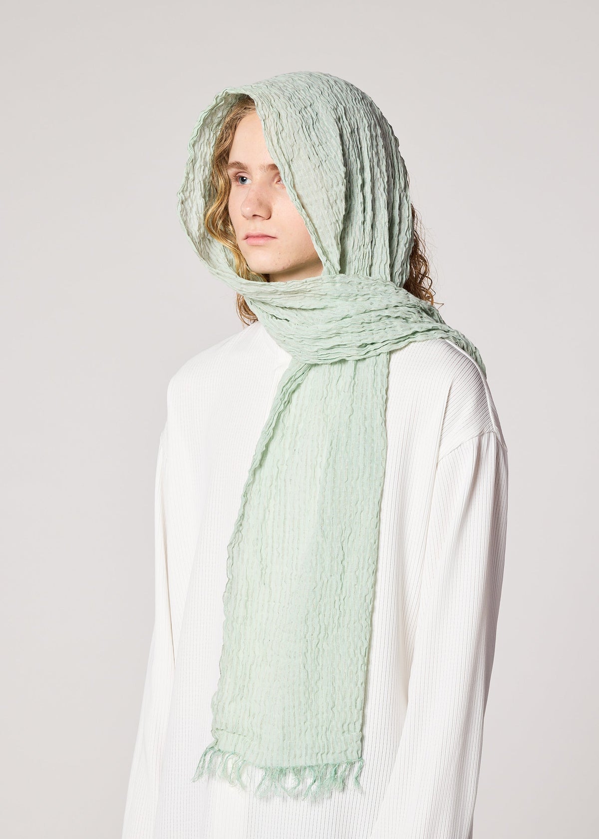 A model wears the IM MEN SHRINK BORDER STOLE stole.