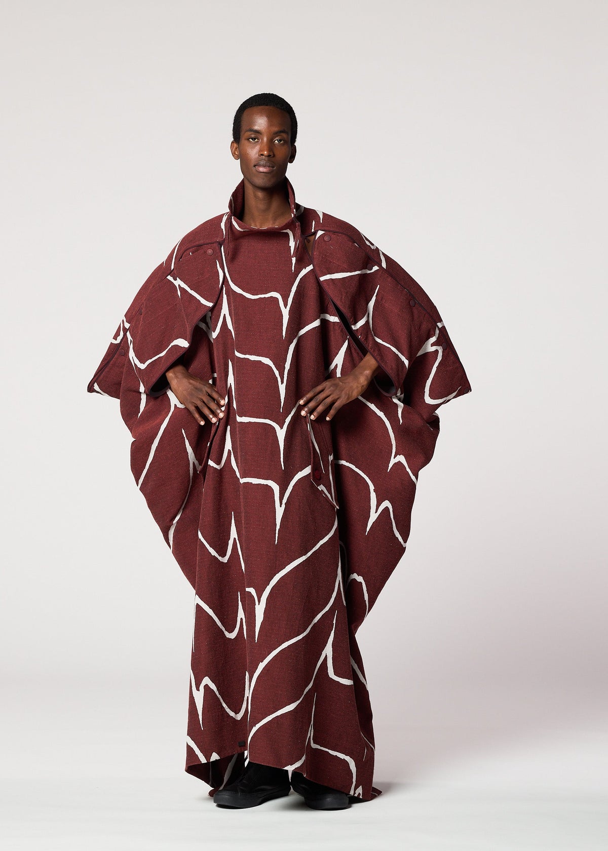 A model wears the IM MEN EARTH coat.