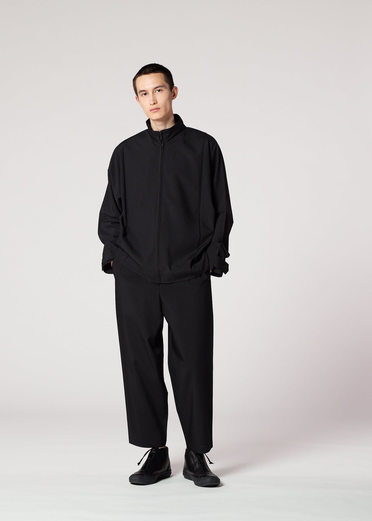 A model wears the IM MEN FLAT BLACK jacket.