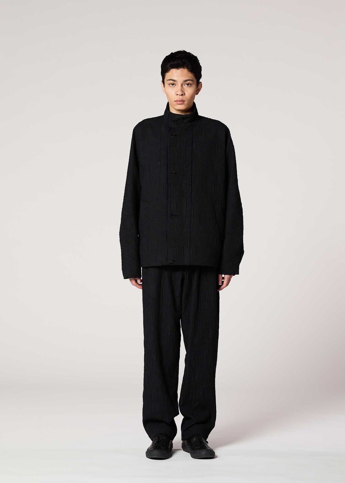 A model wears the IM MEN SHRINK JACQUARD clothing.
