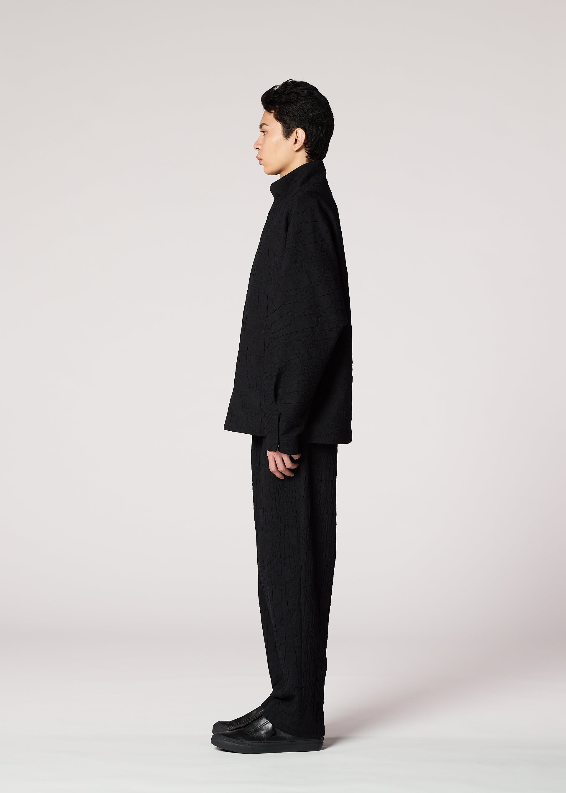 A model wears the IM MEN SHRINK JACQUARD clothing.