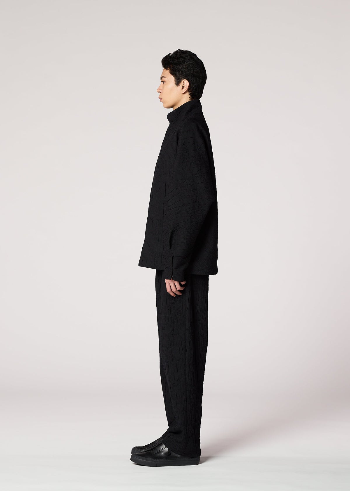 A model wears the IM MEN SHRINK JACQUARD clothing.