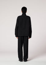 A model wears the IM MEN SHRINK JACQUARD clothing.