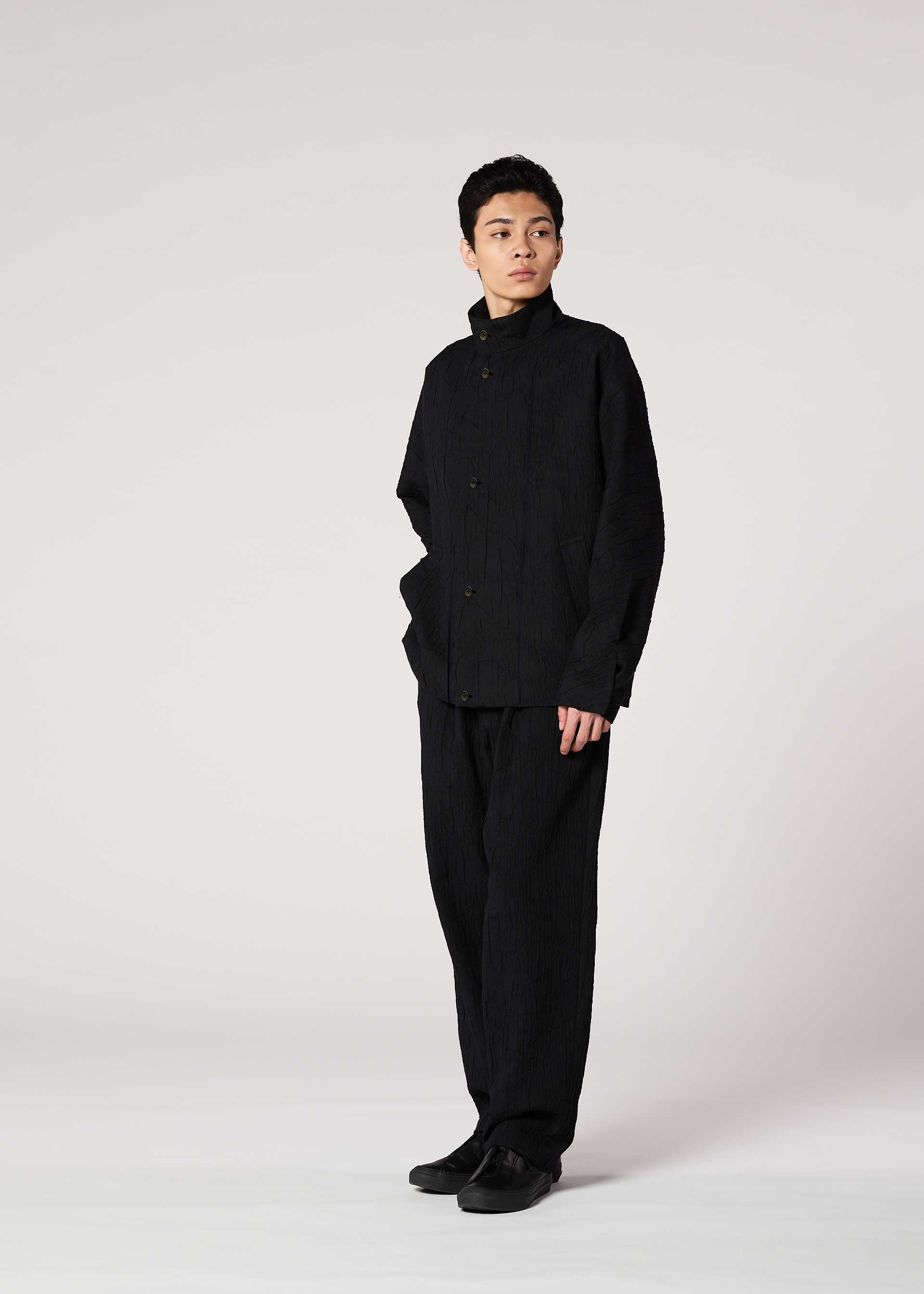 A model wears the IM MEN SHRINK JACQUARD clothing.