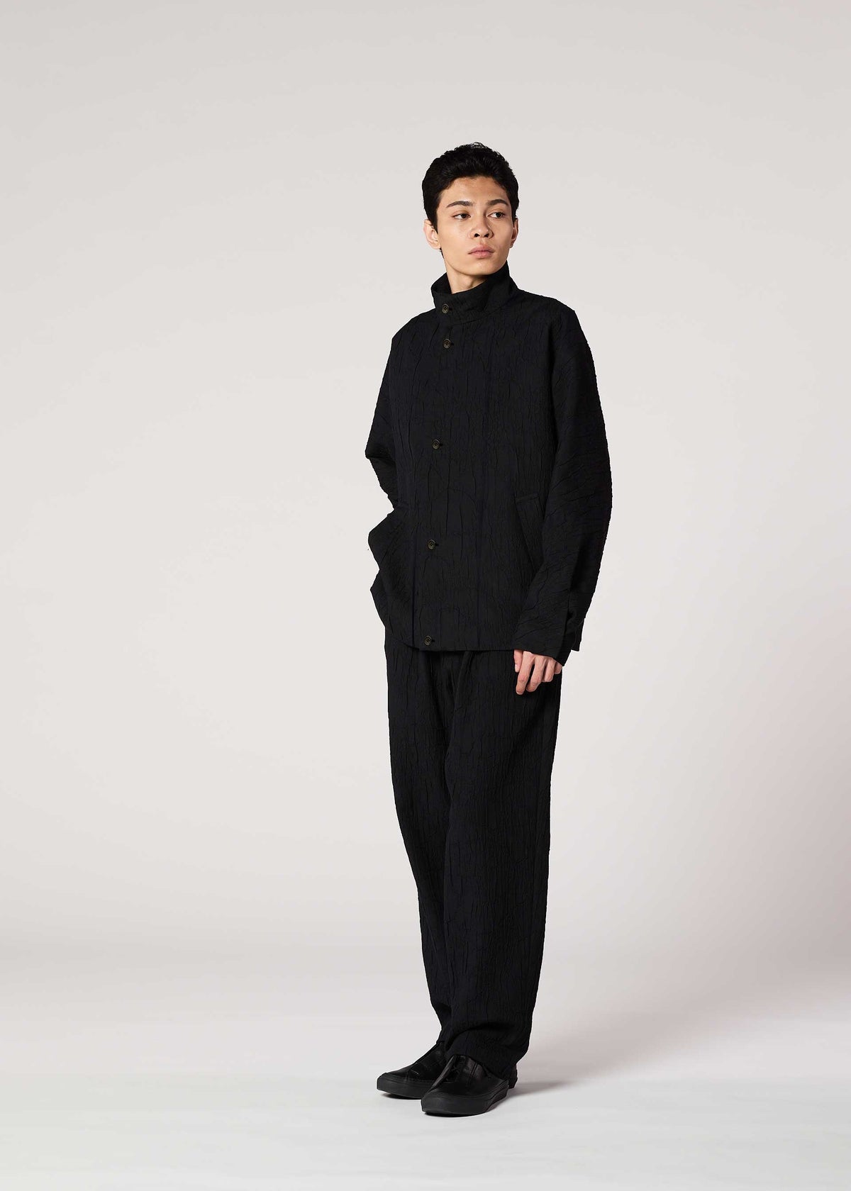 A model wears the IM MEN SHRINK JACQUARD clothing.