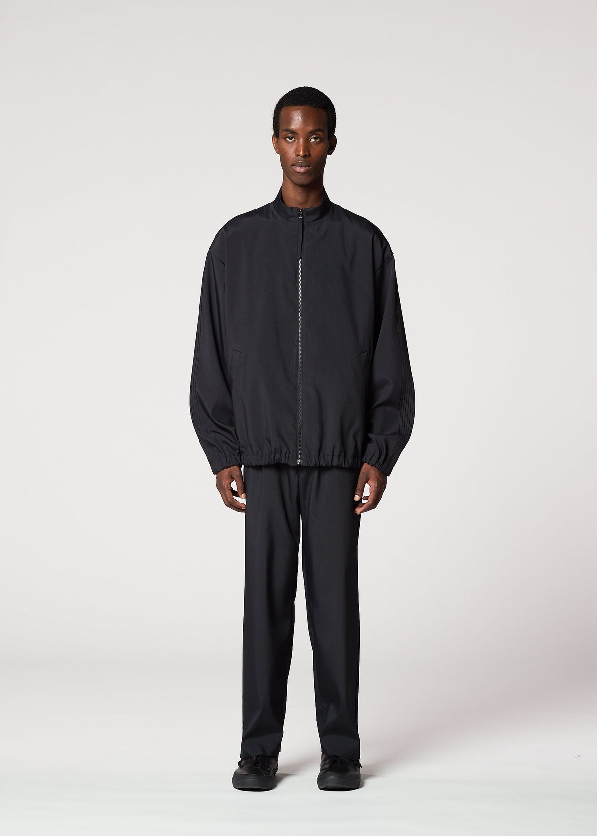 A model wears the IM MEN AIR PLEATS jacket.