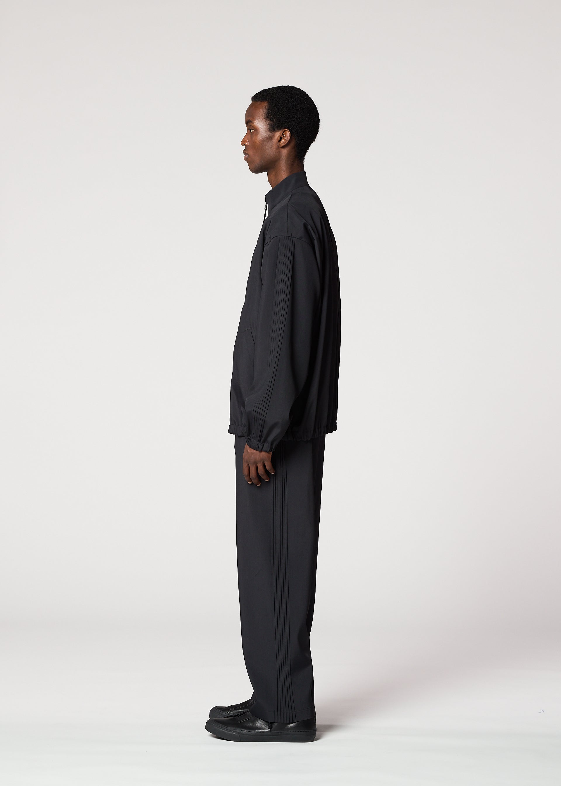 A model wears the IM MEN AIR PLEATS jacket.