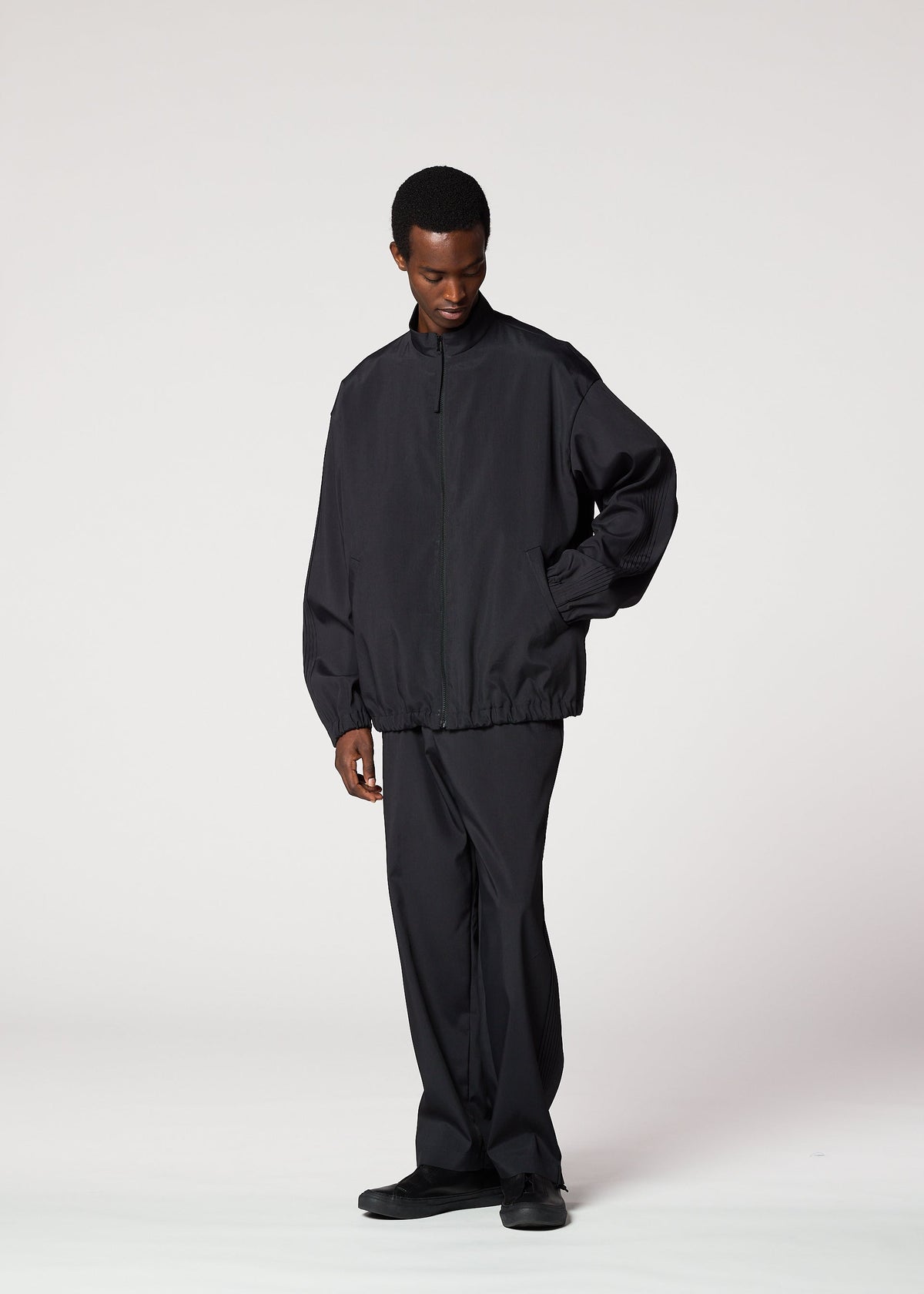 A model wears the IM MEN AIR PLEATS jacket.
