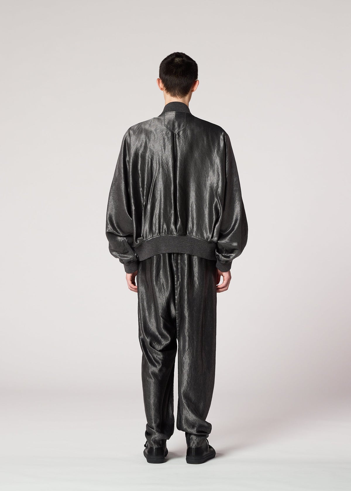 A model wears the IM MEN SATIN WASH jacket.