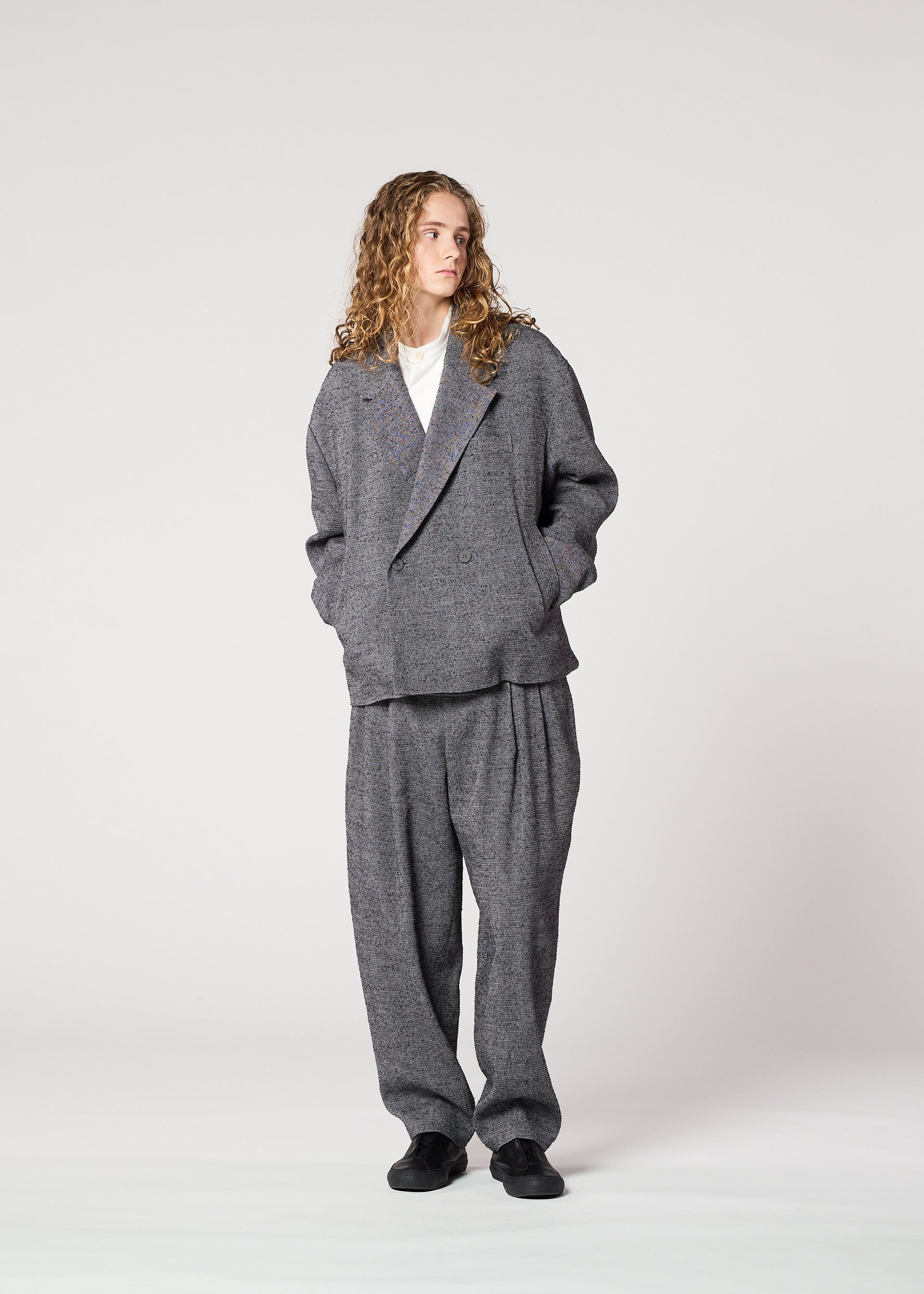 A model wears the IM MEN TEXTURES clothing.