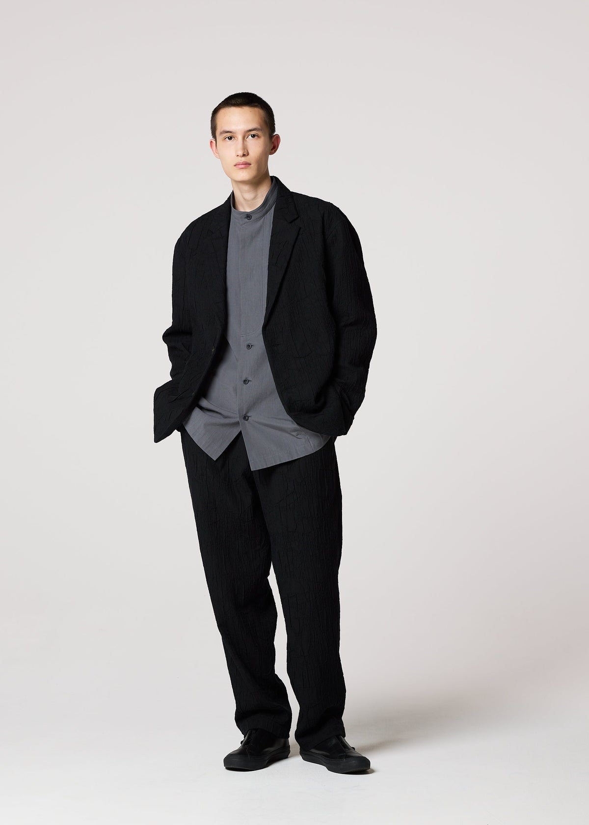 A model wears the IM MEN SHRINK JACQUARD clothing.