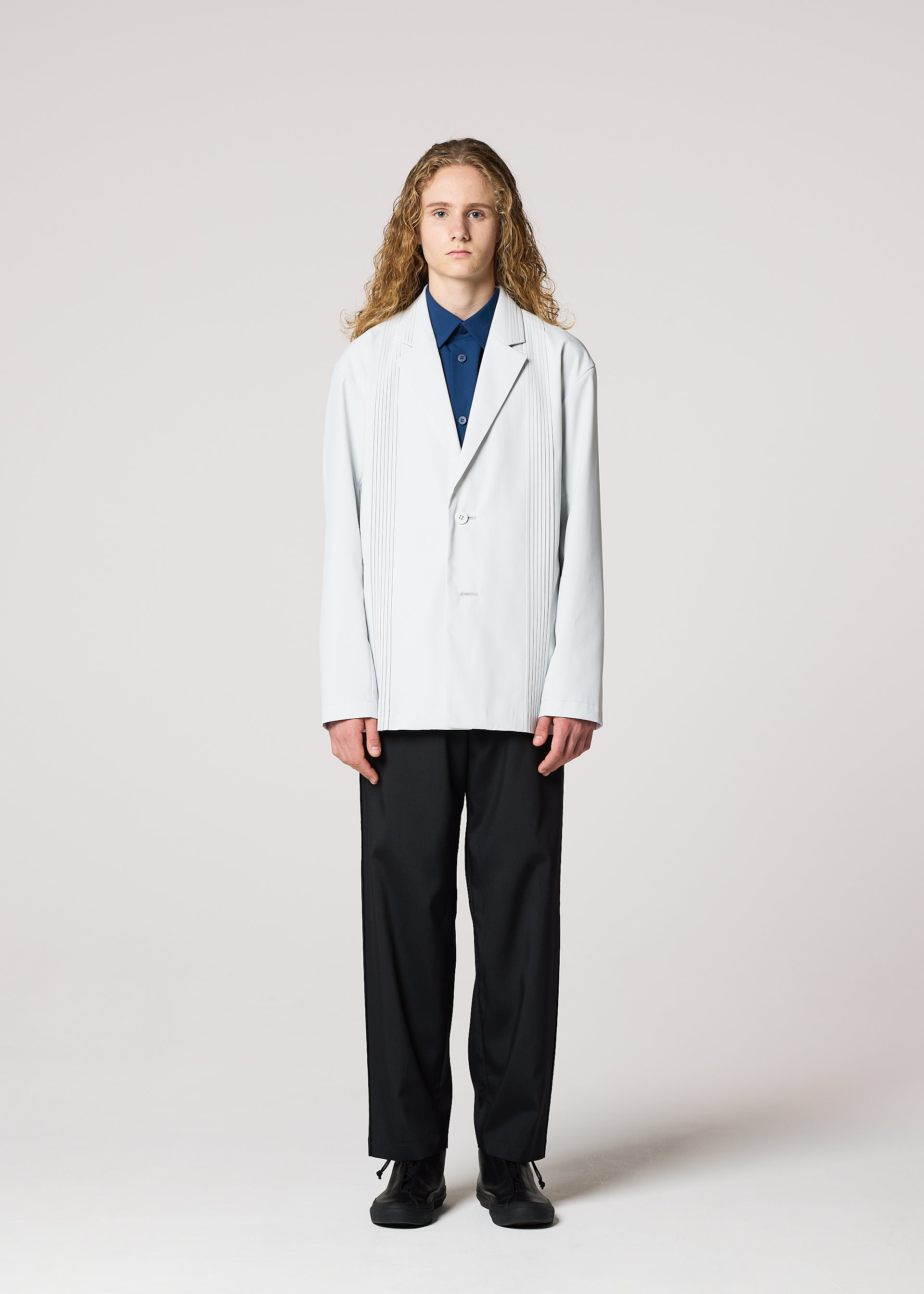 A model wears the IM MEN AIR PLEATS jacket.