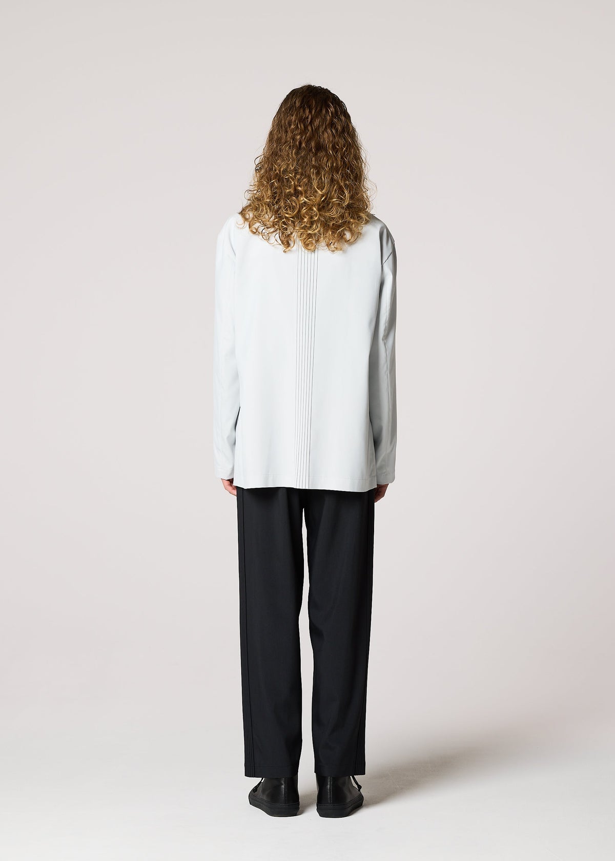 A model wears the IM MEN AIR PLEATS jacket.