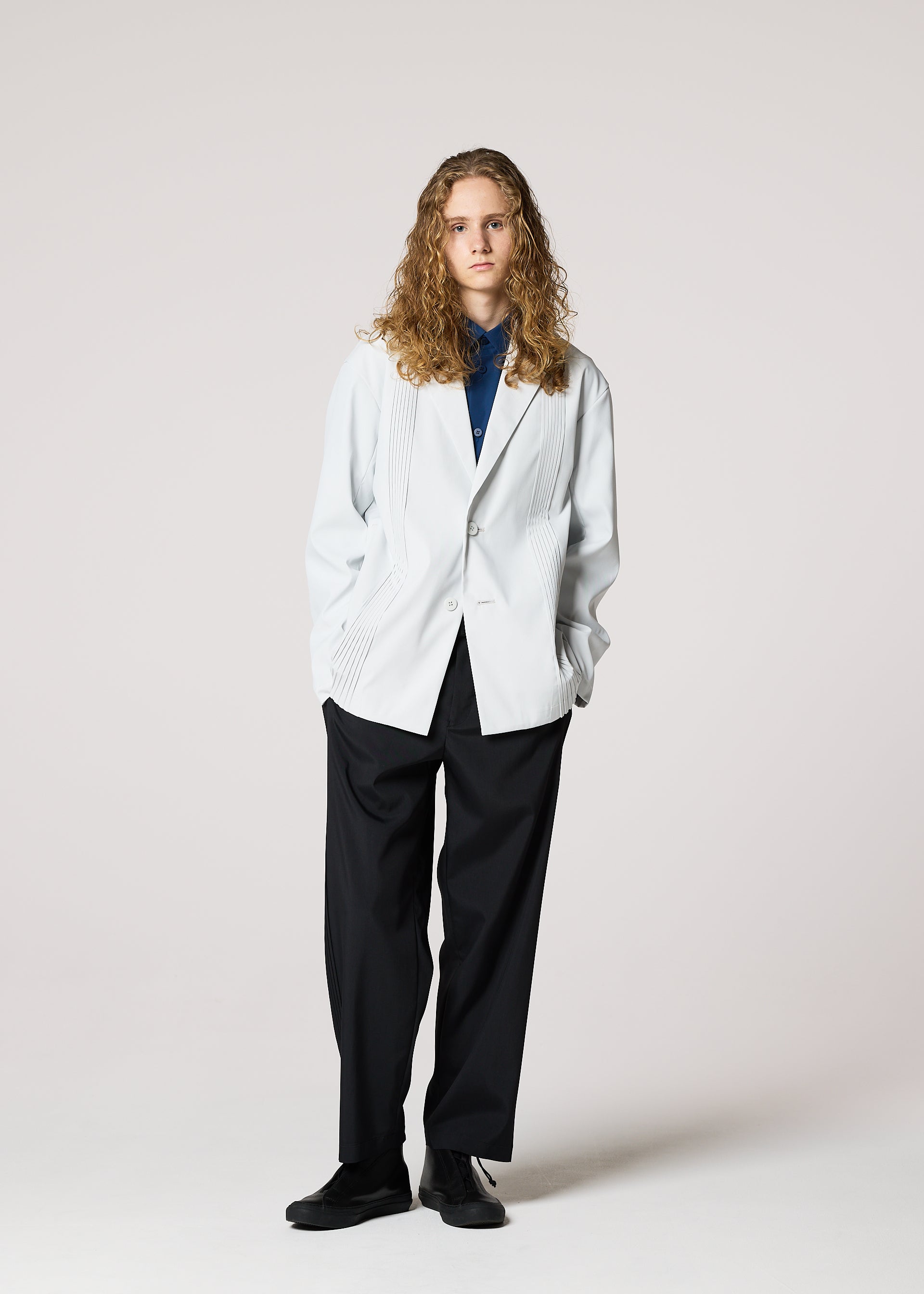 A model wears the IM MEN AIR PLEATS jacket.