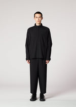 A model wears the IM MEN FLAT BLACK trousers.