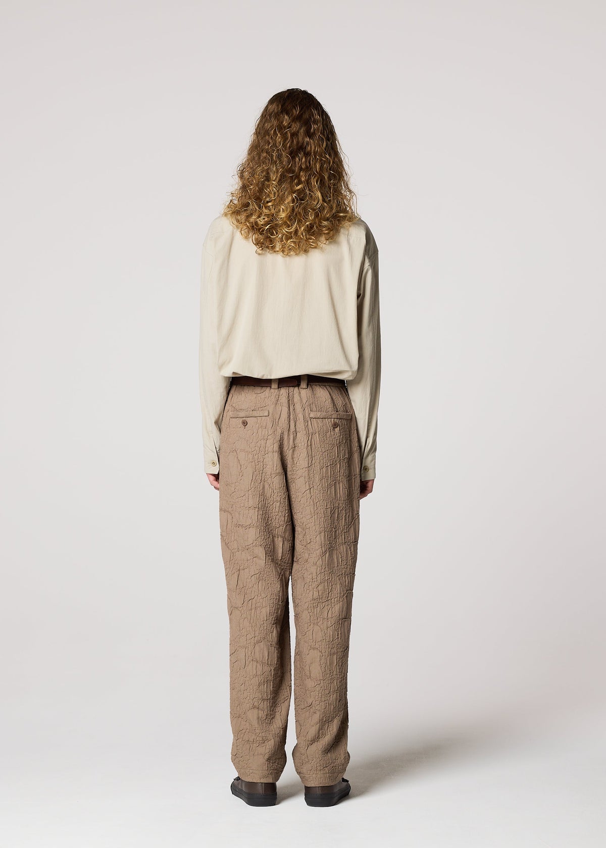A model wears the IM MEN SHRINK JACQUARD clothing.