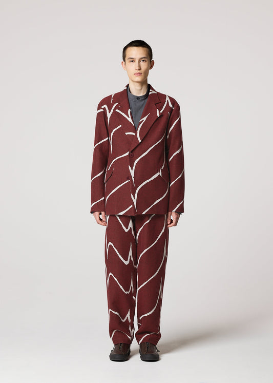 A model wears the IM MEN EARTH trousers.