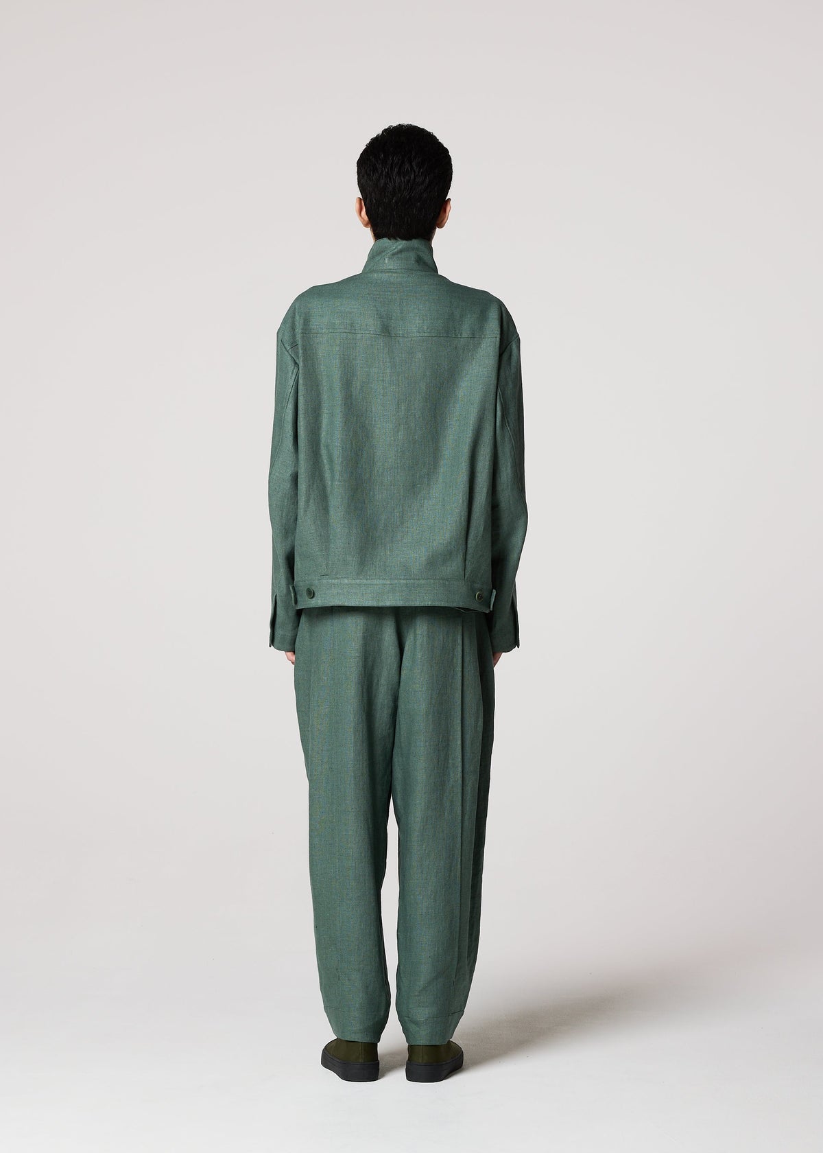 A model wears the IM MEN TOUGH LINEN trousers.