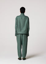 A model wears the IM MEN TOUGH LINEN trousers.