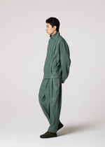 A model wears the IM MEN TOUGH LINEN trousers.