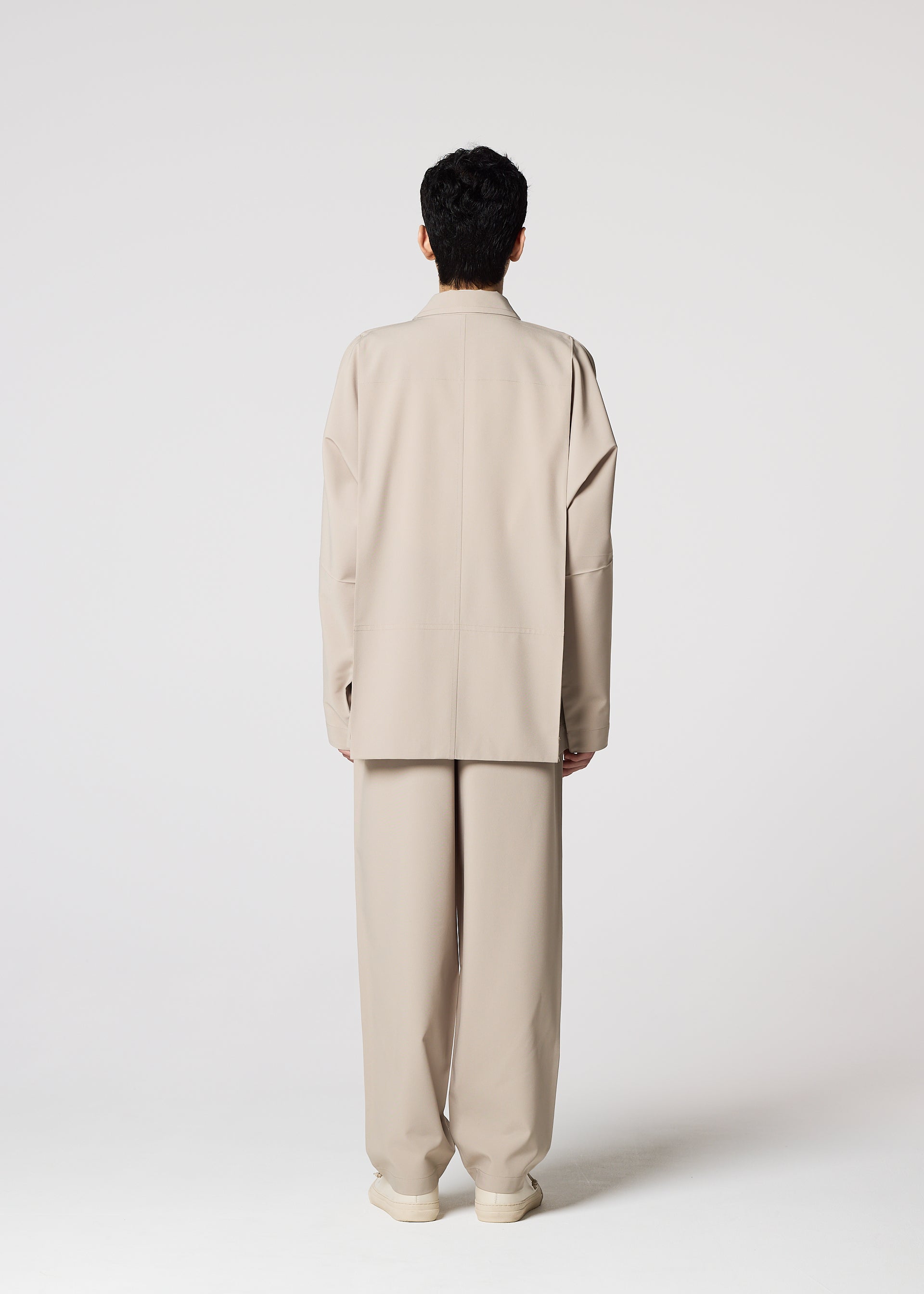 A model wears the IM MEN FLAT trousers.