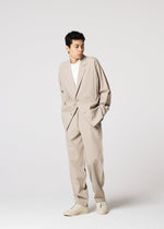 A model wears the IM MEN FLAT trousers.