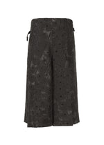 A detail shot of the IM MEN UROKOMON trousers.